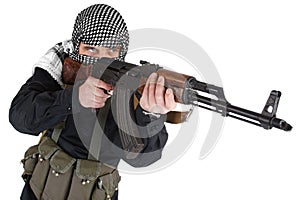 Insurgent dressed in black uniform and black and white shemagh with AK 47 rifle