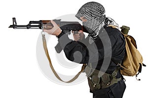 Insurgent dressed in black uniform and black and white shemagh with AK 47 rifle