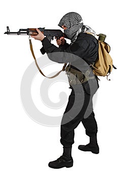 Insurgent dressed in black uniform and black and white shemagh with AK 47 rifle