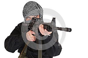 Insurgent dressed in black uniform and black and white shemagh with m4 assault rifle