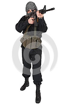 Insurgent dressed in black uniform and black and white shemagh with m4 assault rifle