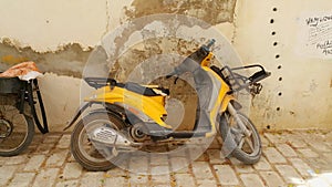 Intage yellow motorcycle in old town located in Djerba Island in Tunisia. photo