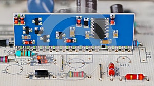 Integrated circuit and surface mounted electronic components on a blue PCB