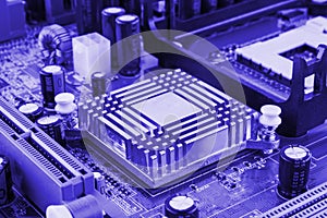 Integrated semiconductor microchip microprocessor on blue circuit board representative of the high tech industry and computer scie