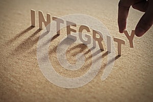 INTEGRITY wood word on compressed board