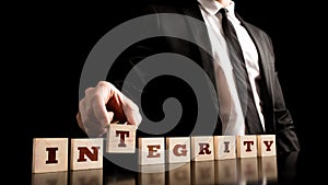 Integrity on Wooden Piece Arranged by Businessman photo