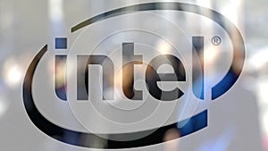 Intel Corporation logo on a glass against blurred crowd on the steet. Editorial 3D rendering