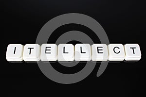 Intellect text word title caption label cover backdrop background. Alphabet letter toy blocks on black reflective background. Whit