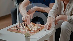 Intellectual people playing chess game with pieces and board