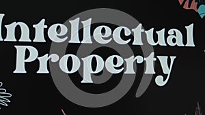 Intellectual Property inscription on black background, graphic presentation. Legal concept