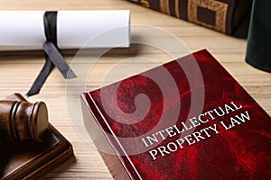 Intellectual Property law book and judge`s gavel on table