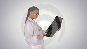 Intellectual woman healthcare personnel with white labcoat, looking at x-ray radiographic image, ct scan, mri on