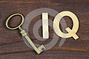 Intelligence quotient, iq test concept, key with letters on a wooden background