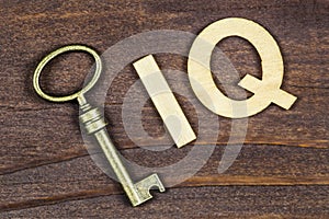 Intelligence quotient, iq test concept, key with letters on a wooden background