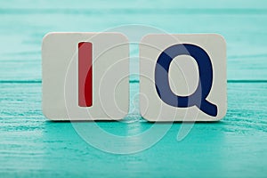 Intelligence quotient. Word IQ on blue wooden background. Copy space. Mock up. School and education concept