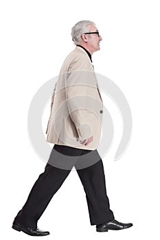 intelligent mature man in a white jacket walking forward .