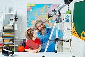 Intelligent, smart ass kids. Games good for brain intelligence concept. Young kid boy playing with Astronomy telescope.