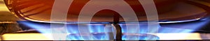 Intense blue gas stove flame under cookware