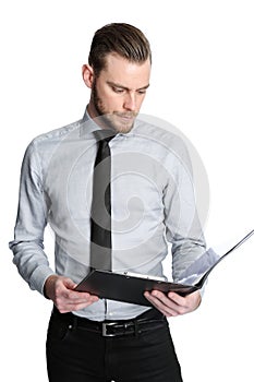 Intense businessman holding a clipboard