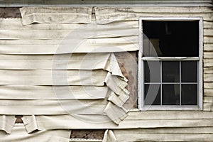 Intense Heat Damaged Vinyl Siding And Window On A Home That Had A Fire