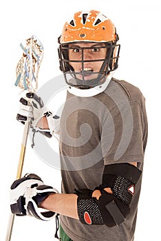 Intense male lacrosse player with helmet and stick