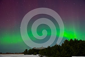 Intense northern lights aurora borealis over beach in Latvia