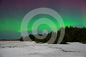 Intense northern lights aurora borealis over beach in Latvia