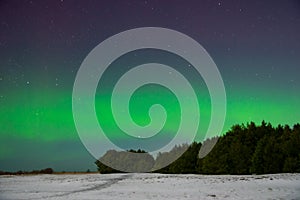 Intense northern lights aurora borealis over beach in Latvia