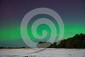 Intense northern lights aurora borealis over beach in Latvia