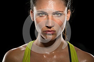 Intense stare eyes determined athlete champion glare head shot sweaty confident woman female powerful fighter close up