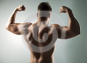 Intensity build immensity. Studio shot of a muscular young man posing against a grey background.