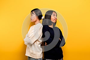 intensity of communication misunderstanding Two friends don't talk to each other after a fight. behind the yellow background