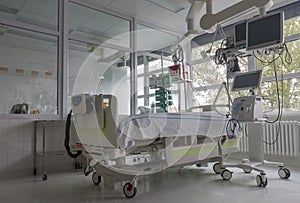 Intensive care unit in hospital, bed with monitors, ventilator, a place where can be  treated patients with pneumonia caused by