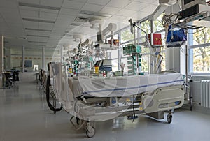 Intensive care unit in hospital, beds with monitors an ventilators, a place where they are treated patients with pneumonia caused