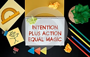 Intention plus action equal magic. Inspirational motivating quote on notebook