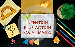 Intention plus action equal magic. Inspirational motivating quote on notebook photo