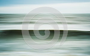 Intentional camera movement of ocean wave photo