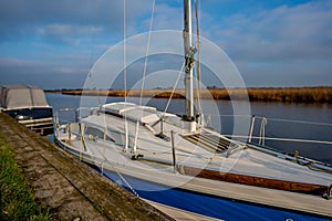 Intentional soft focus on Norfolk Broads sailing boat moored on the River Yare, Acle