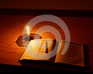 Intentions book lit by candle light in a Department of Conservation hut, Aotearoa / New Zealand