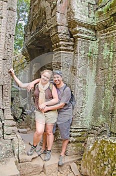 Inter ethnic couple of tourists in Angkor Wat complex