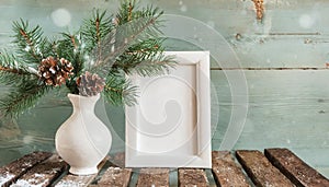 inter still life. Horizontal white frame mockup on vintage wooden bench, table. Modern white ceramic vase with pine tree branches