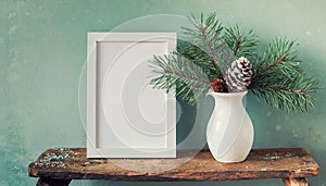 inter still life. Horizontal white frame mockup on vintage wooden bench, table. Modern white ceramic vase with pine tree branches