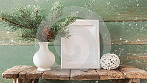 inter still life. Horizontal white frame mockup on vintage wooden bench, table. Modern white ceramic vase with pine tree branches