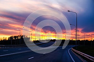 Interchange of the highway. Dramatic sky, fiery sunset. photo