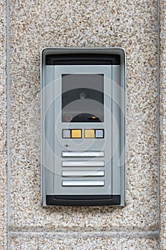 Intercom on the background of a granite wall
