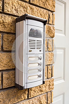 Intercom on a brick wall at the door