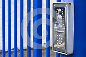 Intercom buzzer on a blue gate
