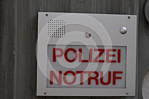 Intercom call box with inscription in German saying police emergency