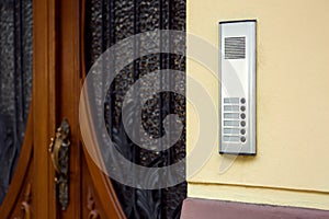 An intercom with a microphone and call buttons.