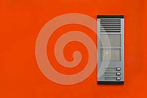 Intercom on the orange wall photo